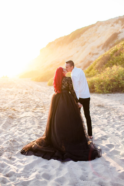 bride and groom kiss in the glowy sunlight