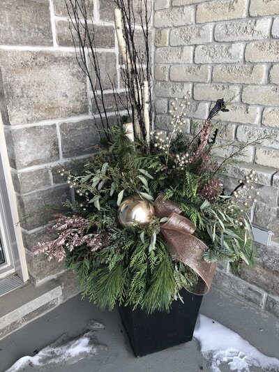 custom holiday planters with greenery and gold berries by Helena's Gardening