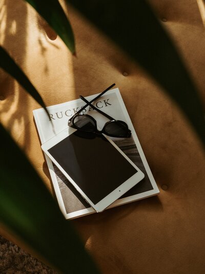 Sunshine hitting sunglasses and magazine on chair - Marrow Design