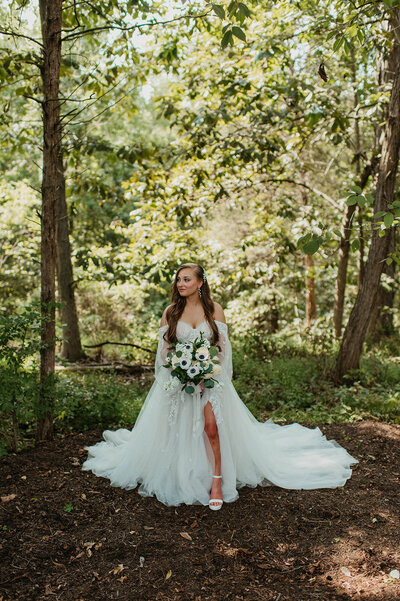 Wedding couple in the field near forest wedding venue in PA.