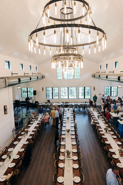 Inside wedding reception tables with chandelier