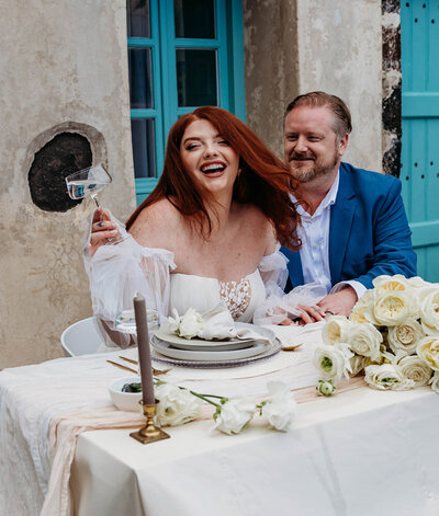 Elopement couple enjoying a romantic table setting in Santorini, Greece.