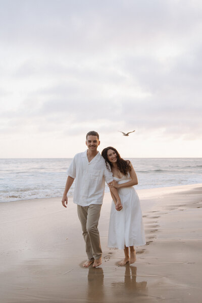 couple holding hands on beach