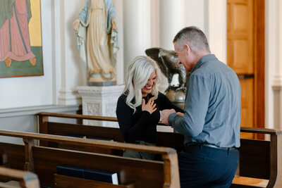 a couple getting engaged in the Sioux Falls Cathedral