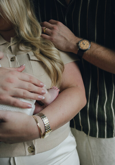 family sitting together in the grass cuddling for a family photoshoot