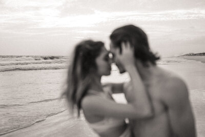 Guy and girl embracing on beach