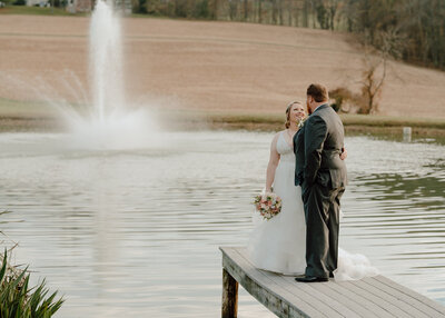 bride and groom next to fountain