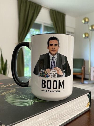 BOOM roasted Office themed coffee mug sitting on plant book in Mid century modern decorated home in Cleveland Ohio. Photo taken by Aaron Aldhizer