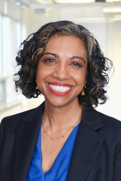 Woman standing smiling at camera