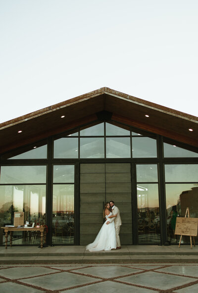 Couple stands in front of a Colorado wedding venue