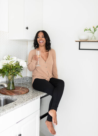 Lawyer sitting on a countertop with a glass of champagne