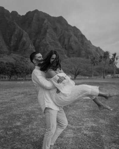 groom holding up bride