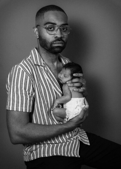 father holding his newborn baby
