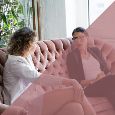 A menopause coach guiding a client in a private coaching session, offering support and strategies.