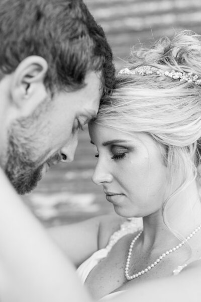 bride and groom standing in front of an old barn in savannah georgia