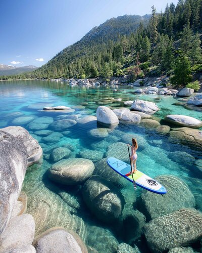 Woman standing on a paddleboard on Lake Tahoe
