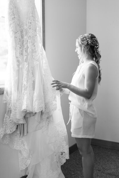 a bride looking at her wedding dress