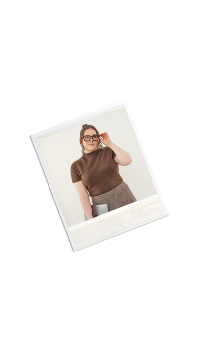 A polaroid photo of the social strategist lead on the Mello Social team holding her laptop.