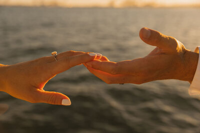 couple touches hands for couples photo session in arizona