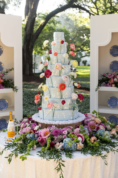Blue wedding cake with bright sugar flowers