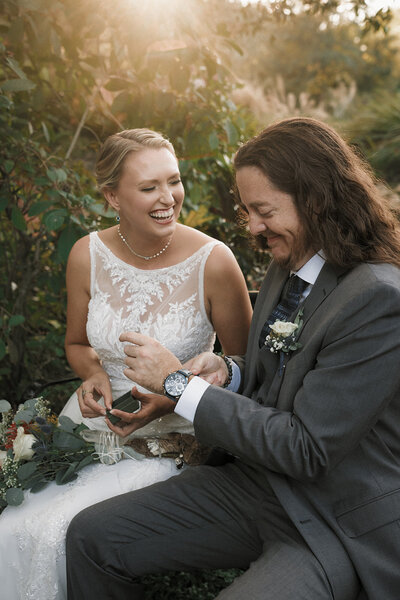 couple gift exchange laughing wedding day