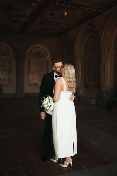 bride and groom standing at city hall