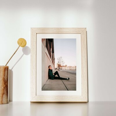 framed photo of teenage boy in Branson landing during senior photography session