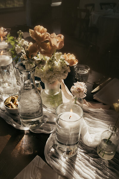 Natural daylight cascades over wedding reception tablescape