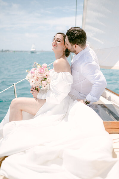 bridal portraits on a boat with floral bouquet