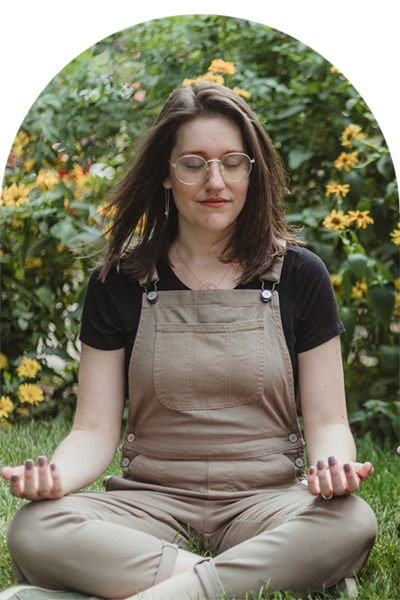 person sitting cross-legged with palms facing up