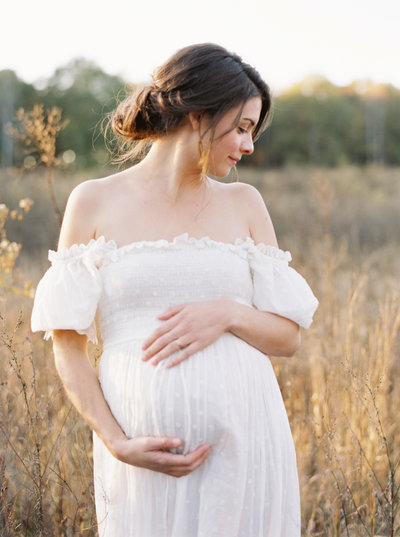 Pregnant woman holding her belly