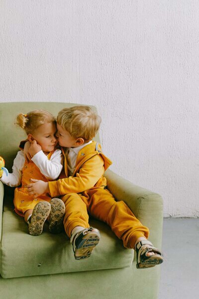 Two siblings engaging with each other in a harmonious activity, showcasing the strength of their bond and the positive impact of peaceful parenting on sibling relationships.