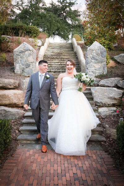 Bride and groom walking down stairs outside