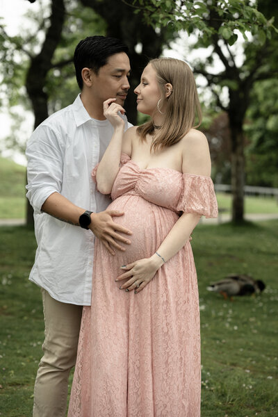 Maternity pictures in Seattle’s Magnuson Park—husband and wife by the water with gentle overcast lighting.