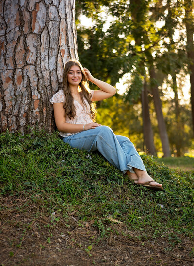Teen Girl jumping on a yellow parking pole in Redlands CA.