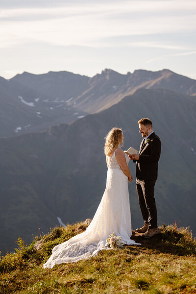 Groom reading vows in PNW Washington mountains