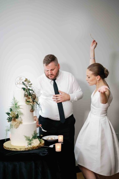 couple cutting their cake at their wedding reception at the international spy museum photographed by richmond wedding photographer omar and co