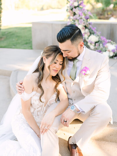 bride and groom sitting down romantic wedding photography 