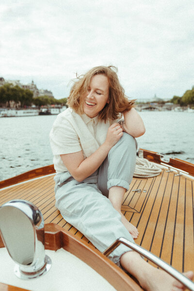 Wedding Photographer based in Tulsa, sitting on a boat laughing
