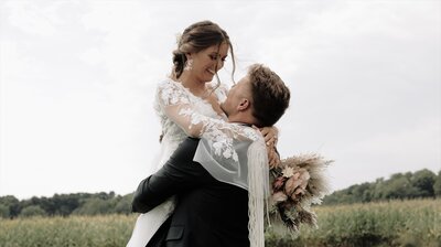 Couple embraces after getting married in a field