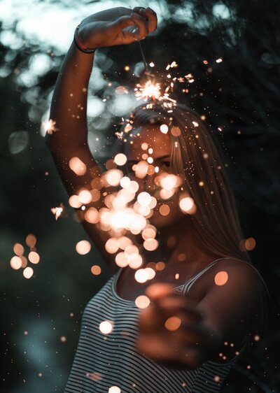 Pretty Girl holding sparklers at night