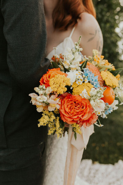 Tangerine inspired florals by Meadow & Vine Floral, romantic Alberta wedding florist, featured on the Brontë Bride Blog.