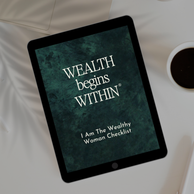 iPad with "Wealth Begins Within, I am the wealthy woman checklist" sits atop table with a palm tree shadow and coffee sitting next to it