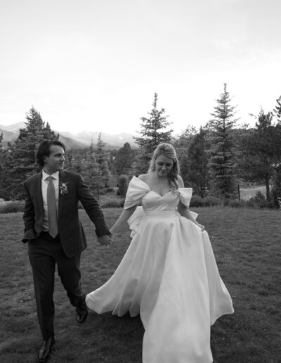 candid photo of bride and groom walking in the mountains in Colorado 