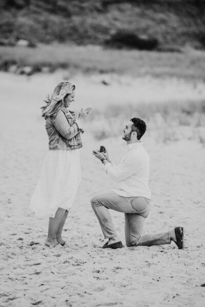 black and white photo of a rainy cape cod proposal on chatham lighthouse beach