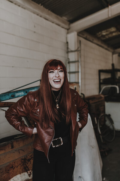 Image of Sarah Kenyon laughing wearing tan leather jacket