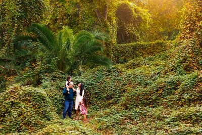 Family of 4 posing for portrait in Escondido and surrounded by greenery