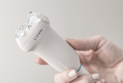 sonographer holding ultrasound probe while preparing to start a private ultrasound business