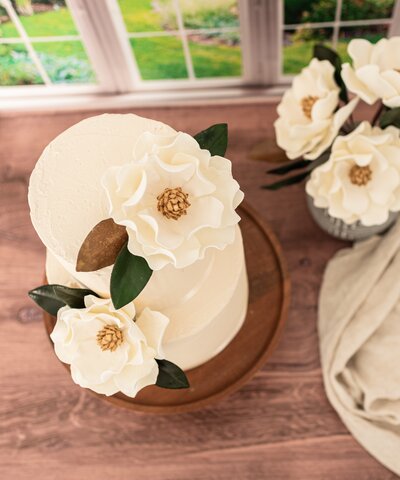 close up of a white and gold open rose gumpaste flower