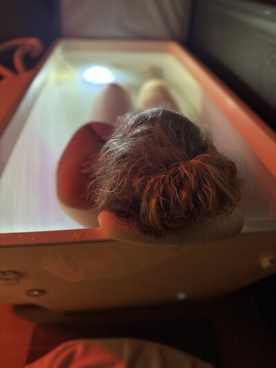 Person submerged in cold plunge ice bath at Vitalis wellness studio for contrast therapy and recovery